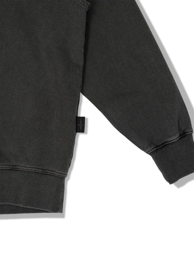PIGMENT FADE SWEATSHIRT in WASHED CHARCOAL, first production run — Side tag (studio, September 2026)